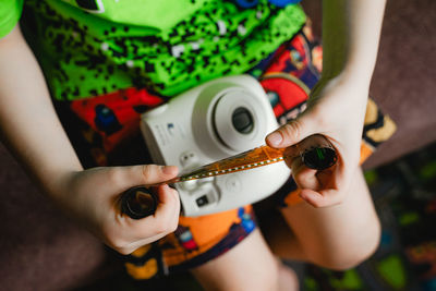 Midsection of woman holding camera