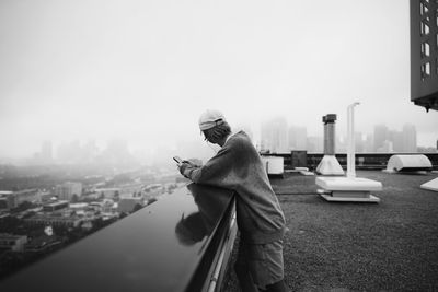 Rear view of woman standing in city