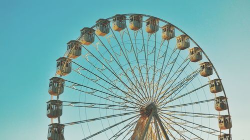 Low angle view of ferris wheel against clear sky