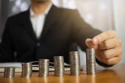 Cropped image of man holding coin stack