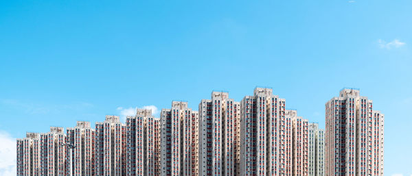 Low angle view of modern buildings against clear blue sky