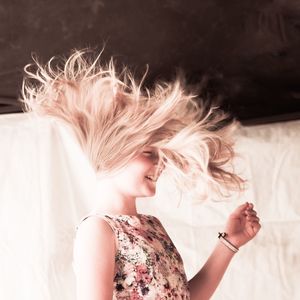 Close-up of smiling girl with tousled hair