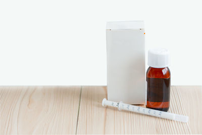 Close-up of drink on table against white background