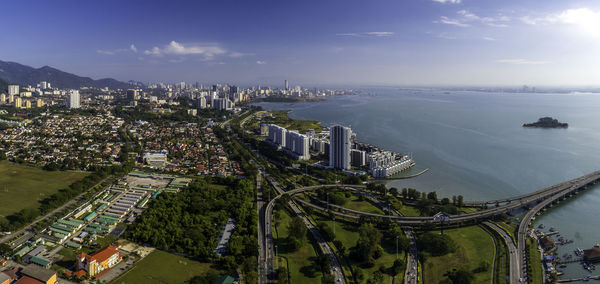 High angle view of buildings by sea against sky