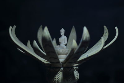 Close-up of statue against black background