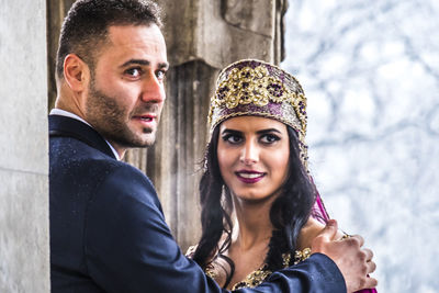 Close-up of couple in traditional clothing standing outdoors