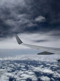 Airplane flying over cloudscape against sky