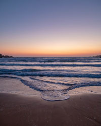Scenic view of sea against clear sky during sunset