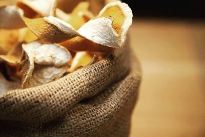 Close-up of dried orange peel in sack