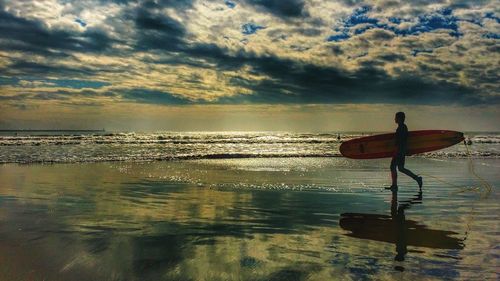 Scenic view of sea against cloudy sky