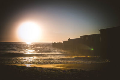 Scenic view of sea against clear sky at sunset
