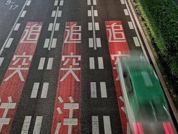 High angle view of road sign on street in city