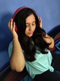 Young woman looking down while sitting