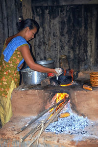 Woman working on barbecue grill