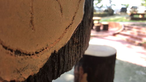 Close-up of metallic structure against tree trunk