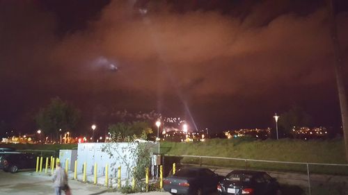 Panoramic view of illuminated city against sky at night