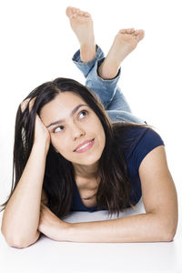 Portrait of smiling young woman against white background