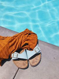 High angle view of sandals at swimming pool