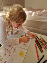 Girl drawing in bedroom 