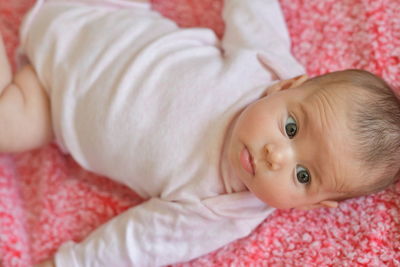 Cute baby girl relaxing on bed