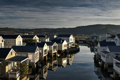 High angle view of townscape by sea against sky