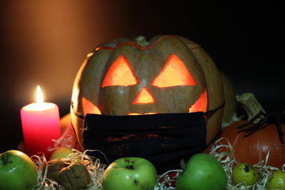 Close-up of illuminated pumpkin against black background