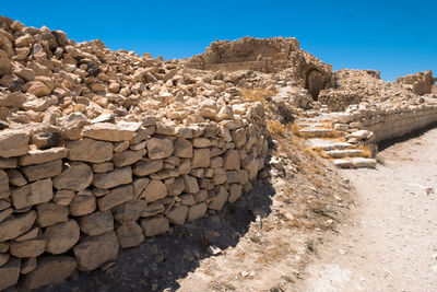 Stack of rocks against clear blue sky