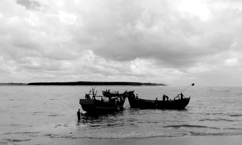 Boat sailing on sea against sky