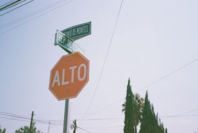 Low angle view of road sign against sky