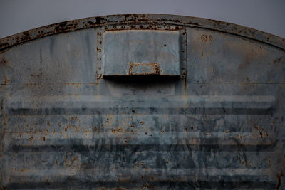 Low angle view of old rusty metal against sky