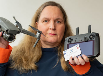 Portrait of woman photographing with mobile phone