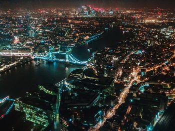 High angle view of city lit up at night