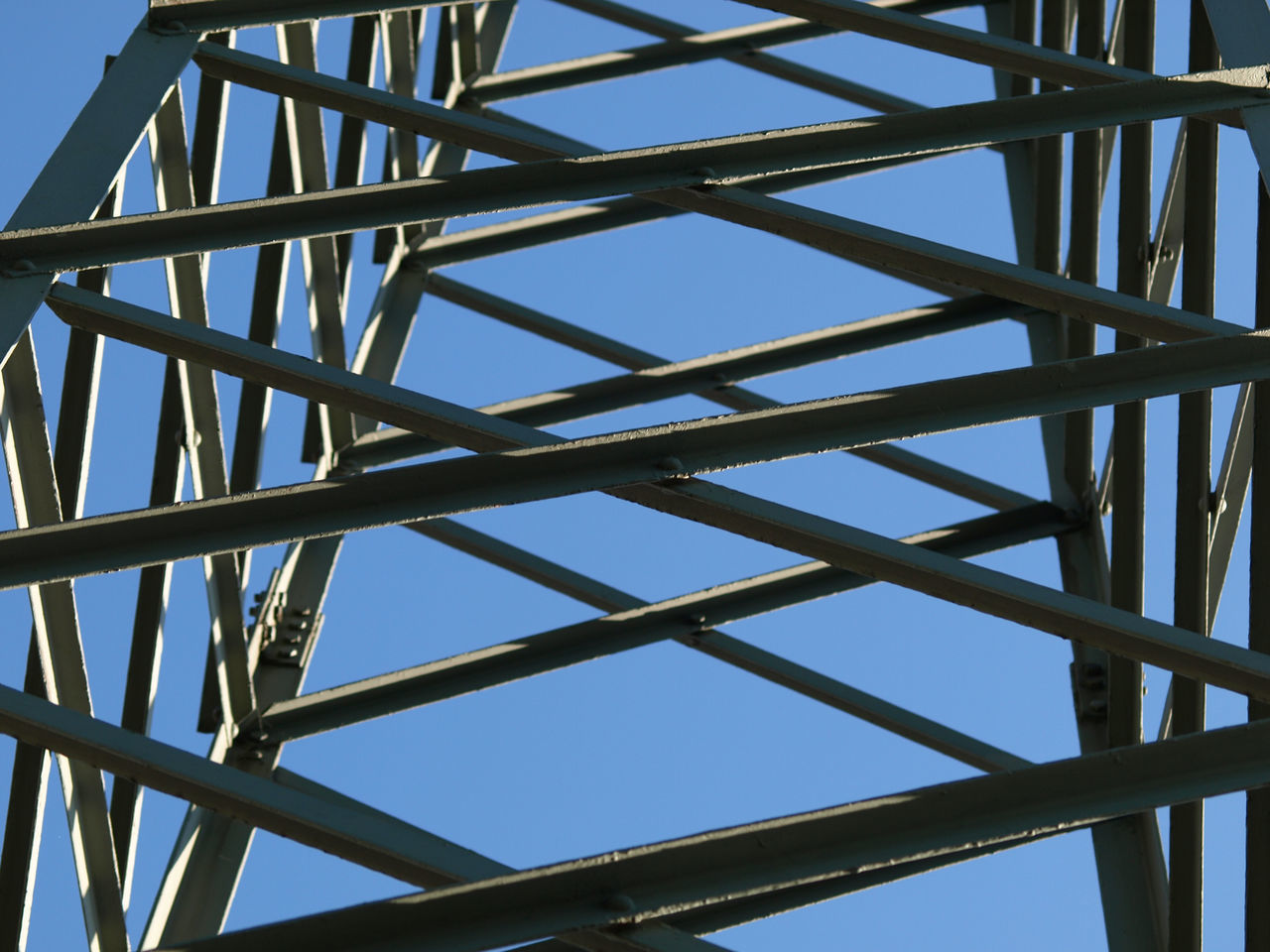LOW ANGLE VIEW OF GRID STRUCTURE AGAINST CLEAR SKY