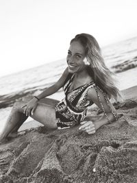 Young woman sitting on beach