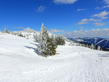 Snow covered landscape against sky