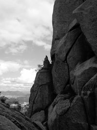 Rock formations against cloudy sky