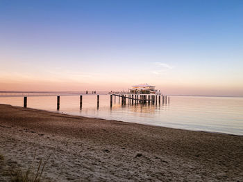 Scenic view of beach against sky during sunset