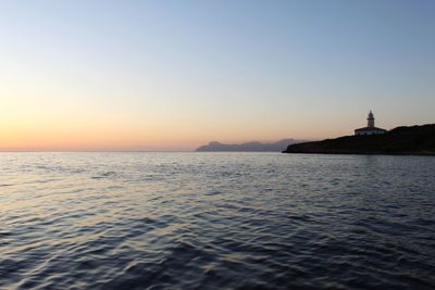 Scenic view of sea against clear sky during sunset