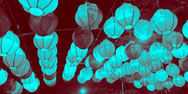 Low angle view of illuminated lanterns hanging on ceiling