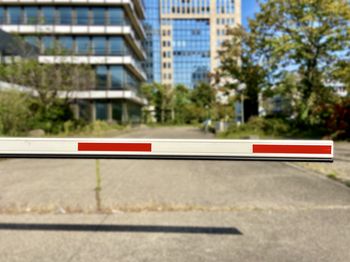 Road sign by building in city