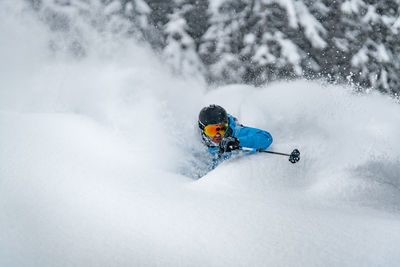 Adult man skiing in deep powder snow in the backcountry, werfenweng, austria.