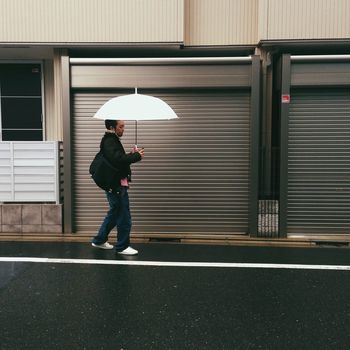 MAN WALKING ON ROAD