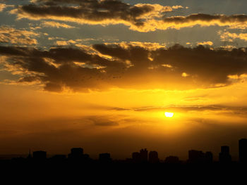 Silhouette landscape against sky during sunset