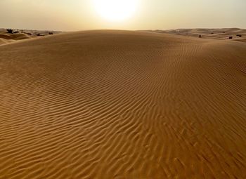 Sand dune in desert against sky