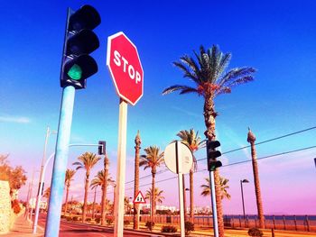 Road sign against blue sky