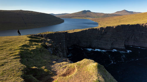 High angle view of man standing on cliff