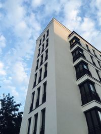 Low angle view of building against cloudy sky
