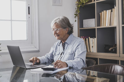 Young man using laptop at home