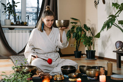 Portrait of young woman sitting at home