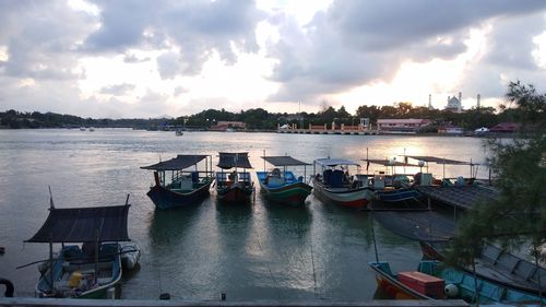 Boats moored in bay against sky